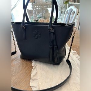 Black leather Tory Burch handbag with crossbody strap.